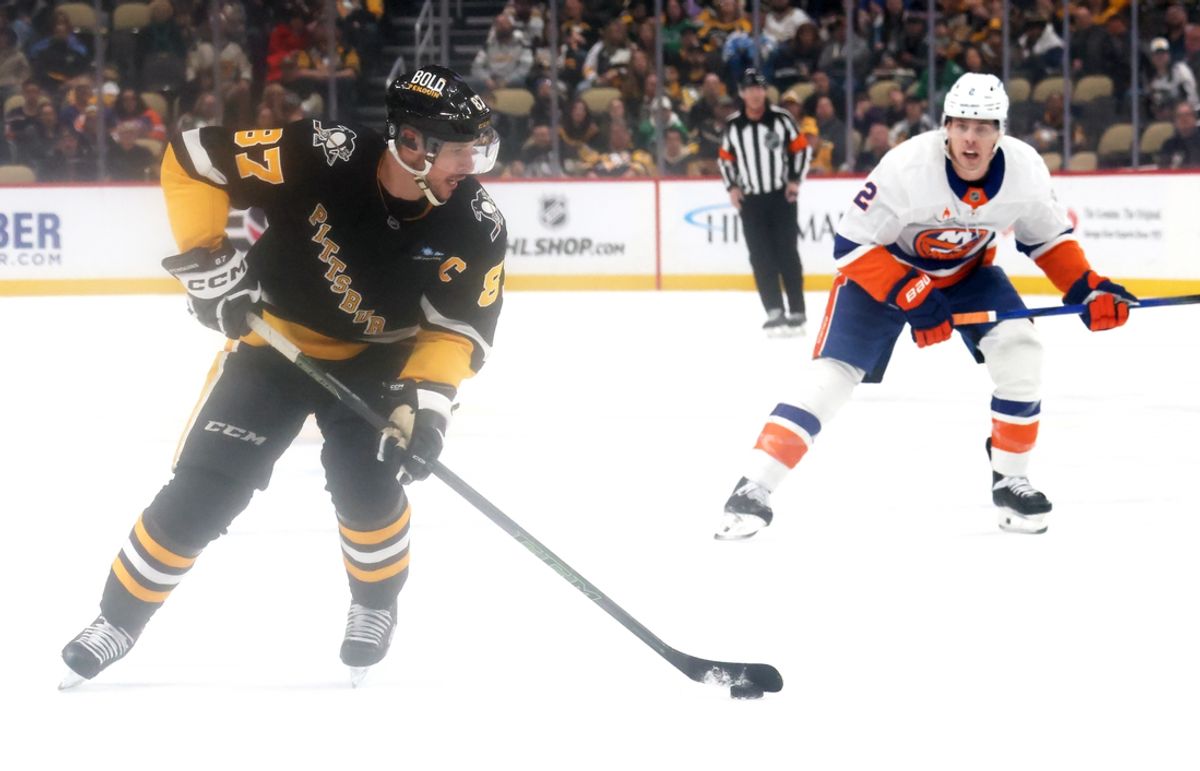 Mar 18, 2025; Pittsburgh, Pennsylvania, USA;  Pittsburgh Penguins center Sidney Crosby (87) skates with the puck against the New York Islanders during the first period at PPG Paints Arena. Mandatory Credit: Charles LeClaire-Imagn Images