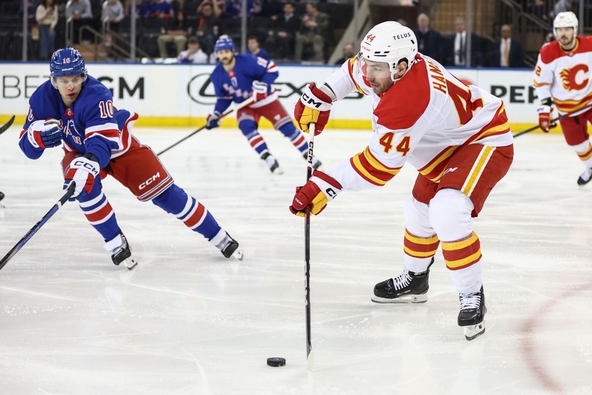 Mar 18, 2025; New York, New York, USA;  Calgary Flames defenseman Joel Hanley (44) passes the puck in the first period against the New York Rangers at Madison Square Garden. Mandatory Credit: Wendell Cruz-Imagn Images