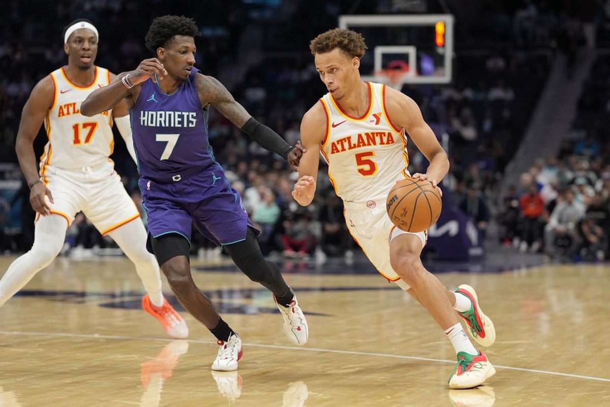 Mar 18, 2025; Charlotte, North Carolina, USA; Atlanta Hawks guard Dyson Daniels (5) goes to the basket against Charlotte Hornets guard Damion Baugh (7) during second quarter at Spectrum Center. Mandatory Credit: Jim Dedmon-Imagn Images