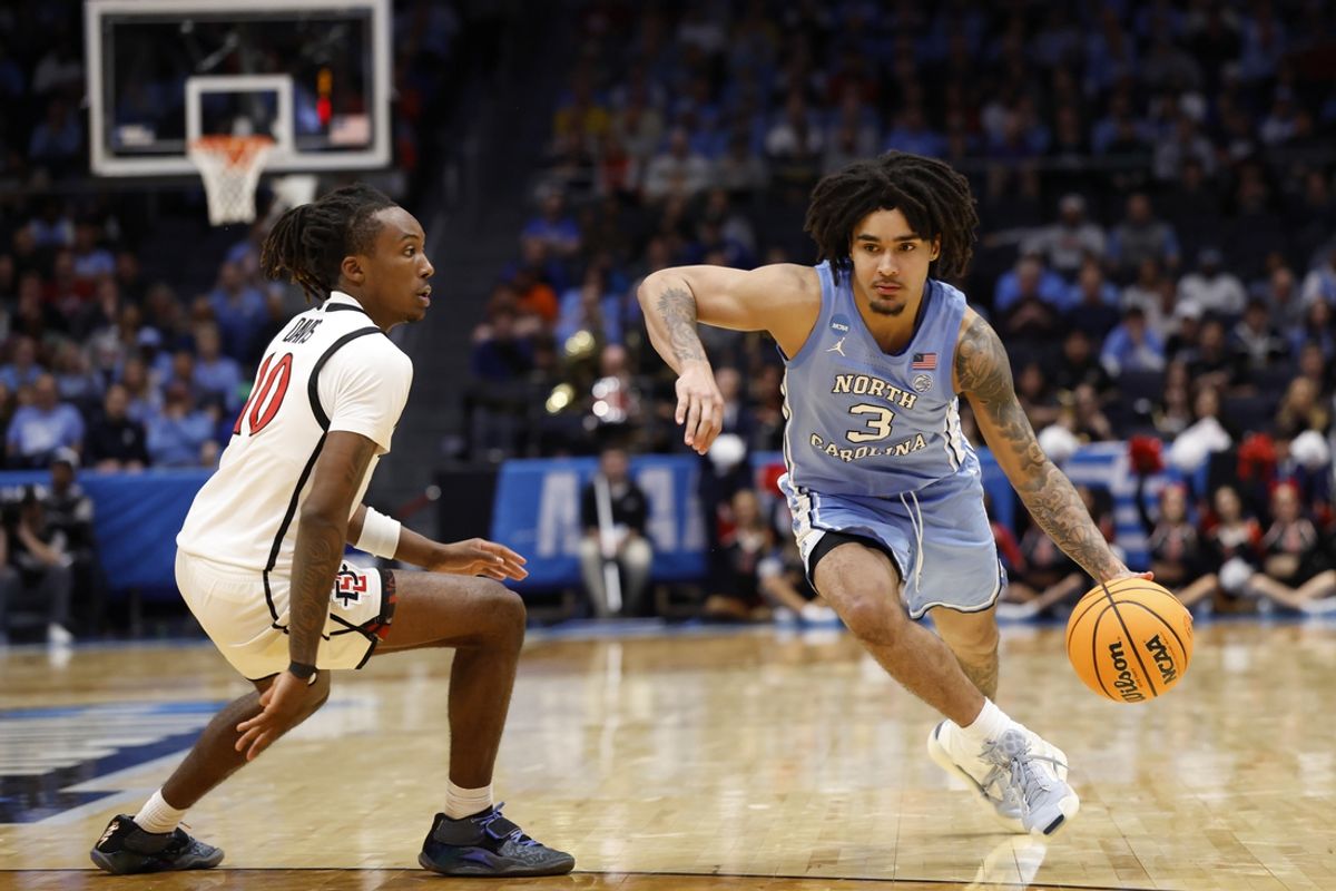 Mar 18, 2025; Dayton, OH, USA; North Carolina Tar Heels guard Elliot Cadeau (3) dribbles the ball defended by San Diego State Aztecs guard BJ Davis (10) in the second half at UD Arena. Mandatory Credit: Rick Osentoski-Imagn Images