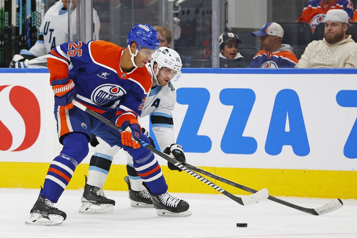 Mar 18, 2025; Edmonton, Alberta, CAN; Edmonton Oilers defensemen Darnell Nurse (25) protects the puck from Utah Hockey Club forward Alex Kerfoot (15) during the second period at Rogers Place. Mandatory Credit: Perry Nelson-Imagn Images