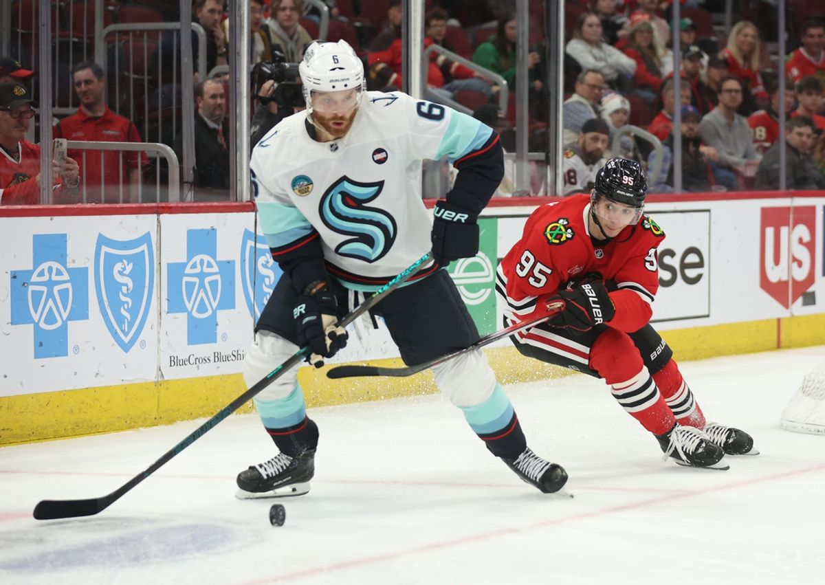 Mar 18, 2025; Chicago, Illinois, USA; Seattle Kraken defenseman Adam Larsson (6) and Chicago Blackhawks right wing Ilya Mikheyev (95) battle for control of the puck during the third period at United Center. Mandatory Credit: Talia Sprague-Imagn Images