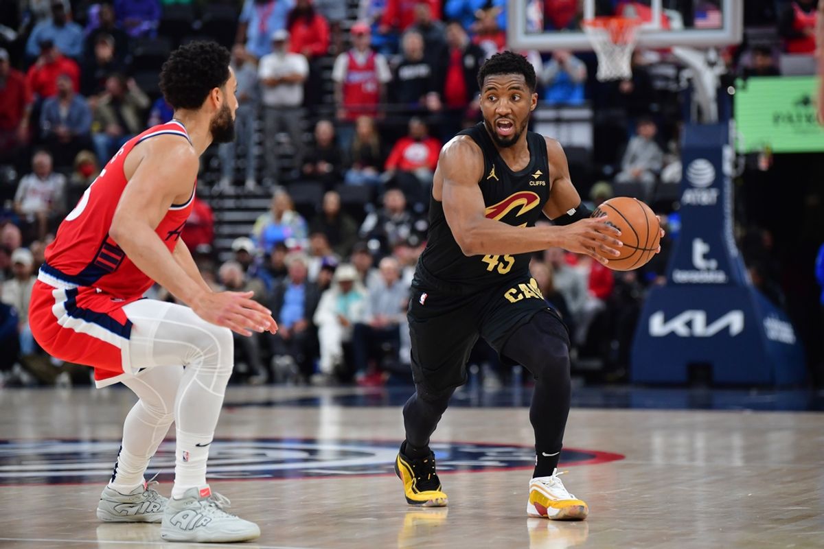 Mar 18, 2025; Inglewood, California, USA; Cleveland Cavaliers guard Donovan Mitchell (45) moves the ball against Los Angeles Clippers guard Ben Simmons (25) during the first half at Intuit Dome. Mandatory Credit: Gary A. Vasquez-Imagn Images