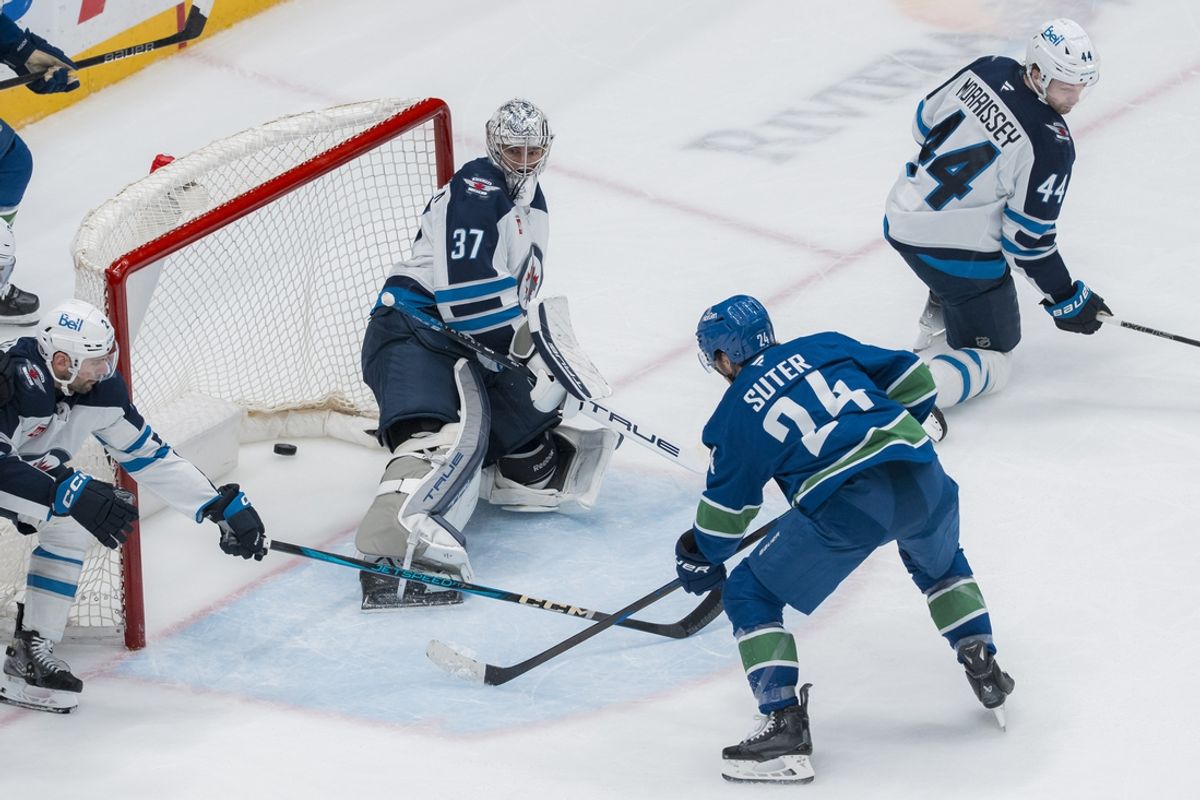Mar 18, 2025; Vancouver, British Columbia, CAN; Winnipeg Jets defenseman Dylan DeMelo (2) and defenseman Josh Morrissey (44) watch as Vancouver Canucks forward Pius Suter (24) scores on goalie Connor Hellebuyck (37) in the second period at Rogers Arena. Mandatory Credit: Bob Frid-Imagn Images