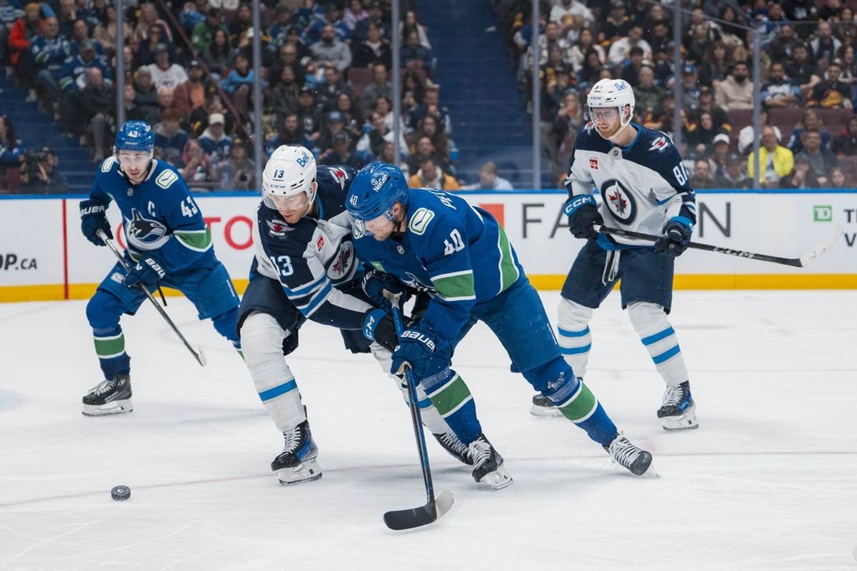 Mar 18, 2025; Vancouver, British Columbia, CAN; Winnipeg Jets forward Gabriel Vilardi (13) battles with Vancouver Canucks forward Elias Pettersson (40) in the third period at Rogers Arena. Mandatory Credit: Bob Frid-Imagn Images