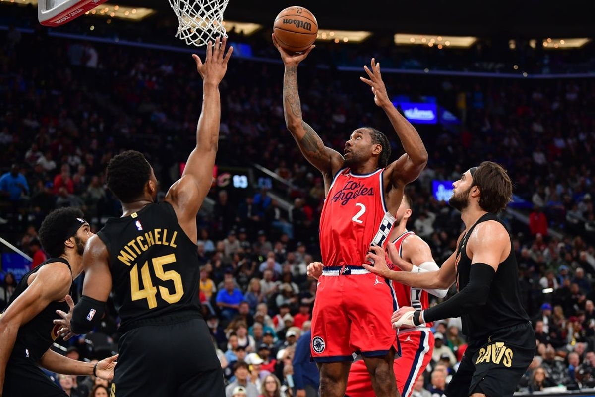 Mar 18, 2025; Inglewood, California, USA; Los Angeles Clippers forward Kawhi Leonard (2) shoots against Cleveland Cavaliers guard Donovan Mitchell (45) during the second half at Intuit Dome. Mandatory Credit: Gary A. Vasquez-Imagn Images