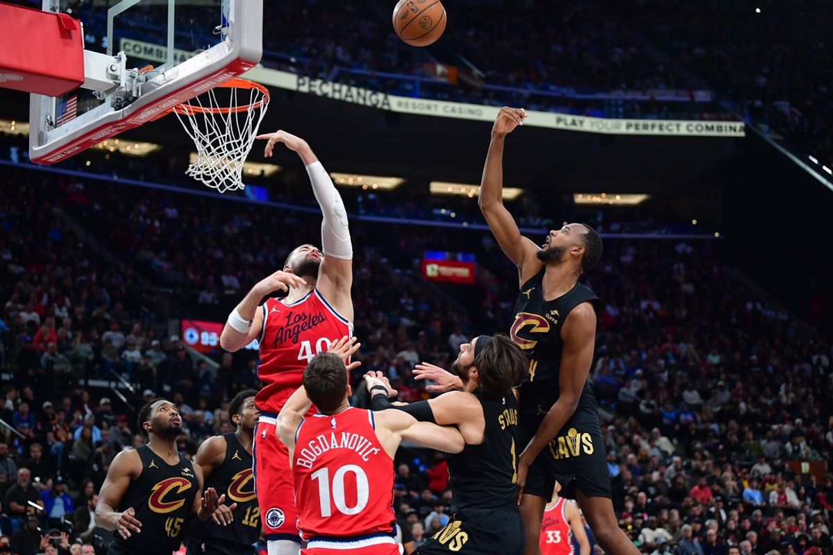 Mar 18, 2025; Inglewood, California, USA; Los Angeles Clippers center Ivica Zubac (40) and Cleveland Cavaliers forward Evan Mobley (4) play for the rebound during the second half at Intuit Dome. Mandatory Credit: Gary A. Vasquez-Imagn Images