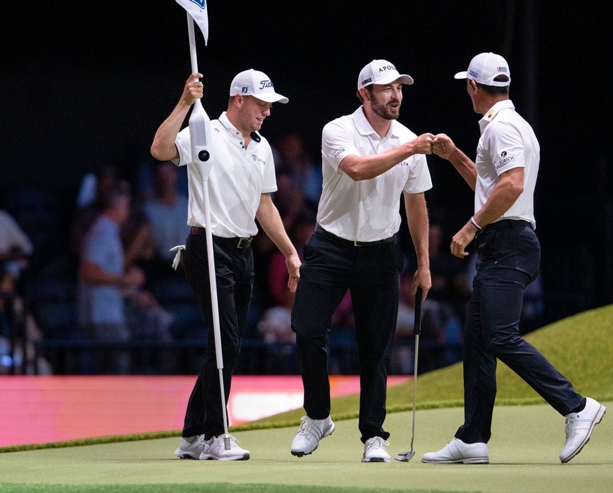 Patrick Cantlay fist bumps Billy Horschel, next to Justin Thomas of Atlanta Drive GC after making a putt against Bay Club Golf in the TGL semifinal match at SoFi Center on March 18, 2025, in Palm Beach Gardens, Florida.