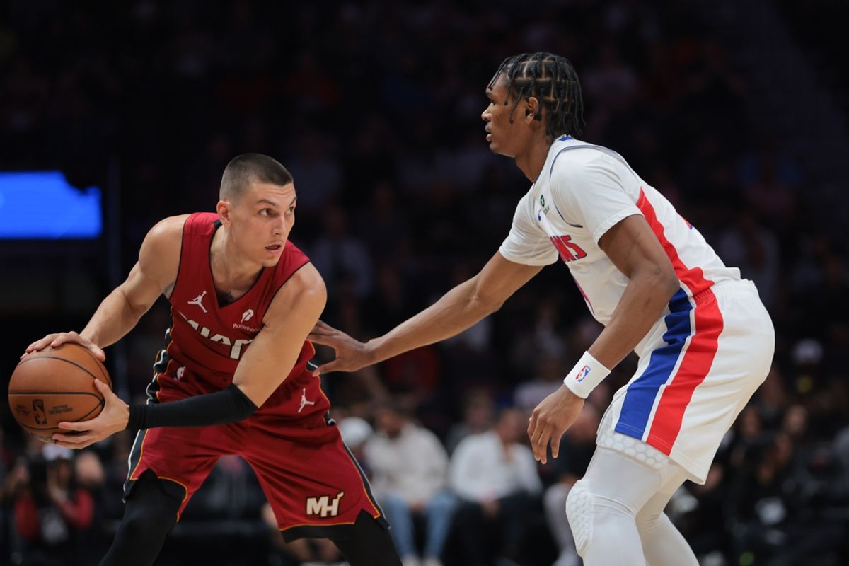 Mar 19, 2025; Miami, Florida, USA; Miami Heat guard Tyler Herro (14) protects the basketball from Detroit Pistons forward Ausar Thompson (9) during the first quarter at Kaseya Center. Mandatory Credit: Sam Navarro-Imagn Images