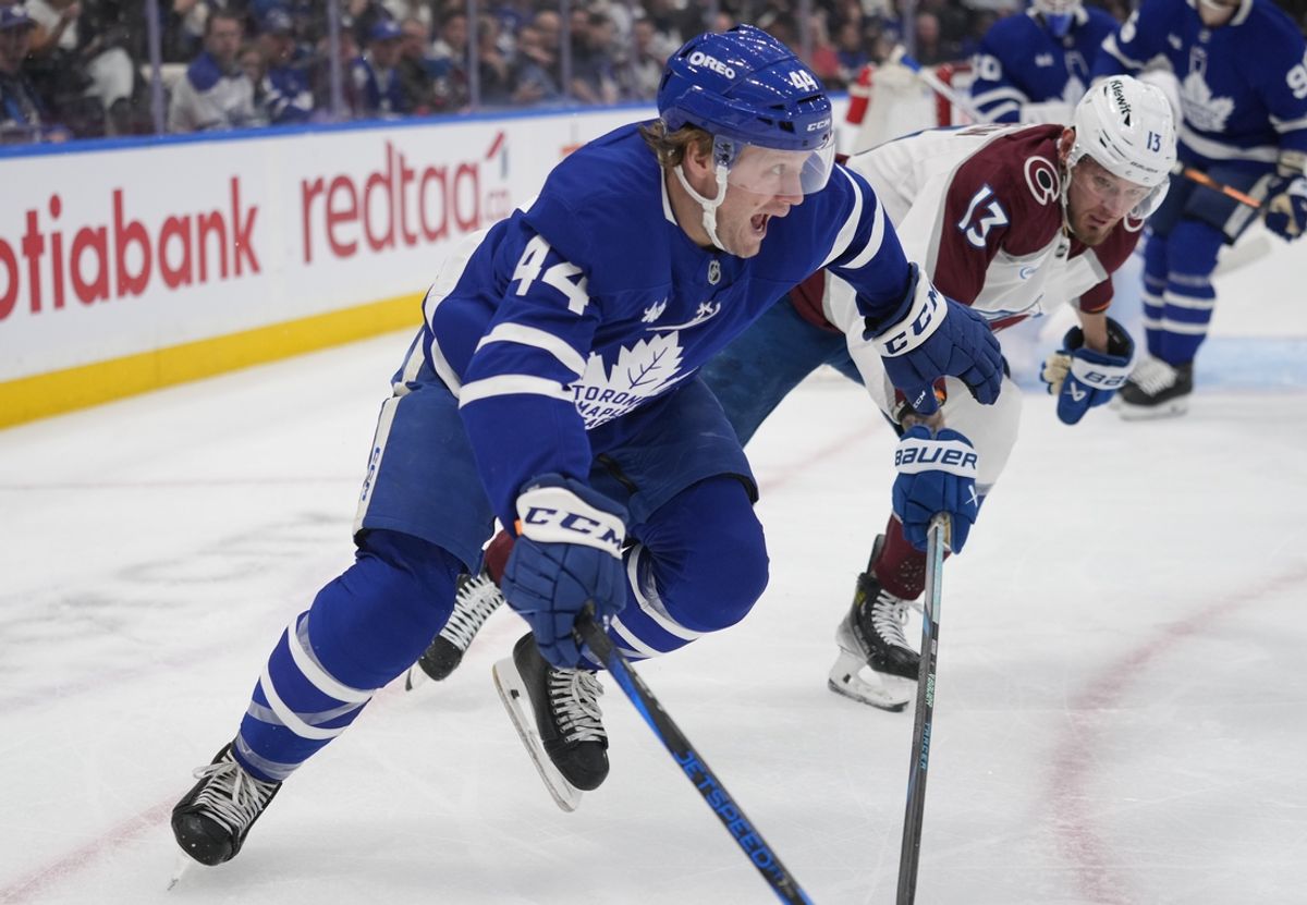 Mar 19, 2025; Toronto, Ontario, CAN; Toronto Maple Leafs defenceman Morgan Rielly (44) heads up ice against Colorado Avalanche forward Valeri Nichushkin (13) during the first period at Scotiabank Arena. Mandatory Credit: John E. Sokolowski-Imagn Images