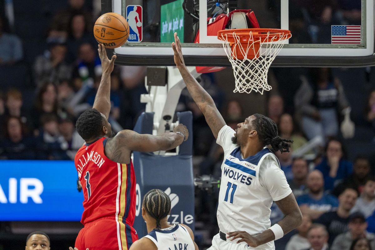 Mar 19, 2025; Minneapolis, Minnesota, USA; New Orleans Pelicans forward Zion Williamson (1) shoots the ball over Minnesota Timberwolves center Naz Reid (11) in the first half at Target Center. Mandatory Credit: Jesse Johnson-Imagn Images