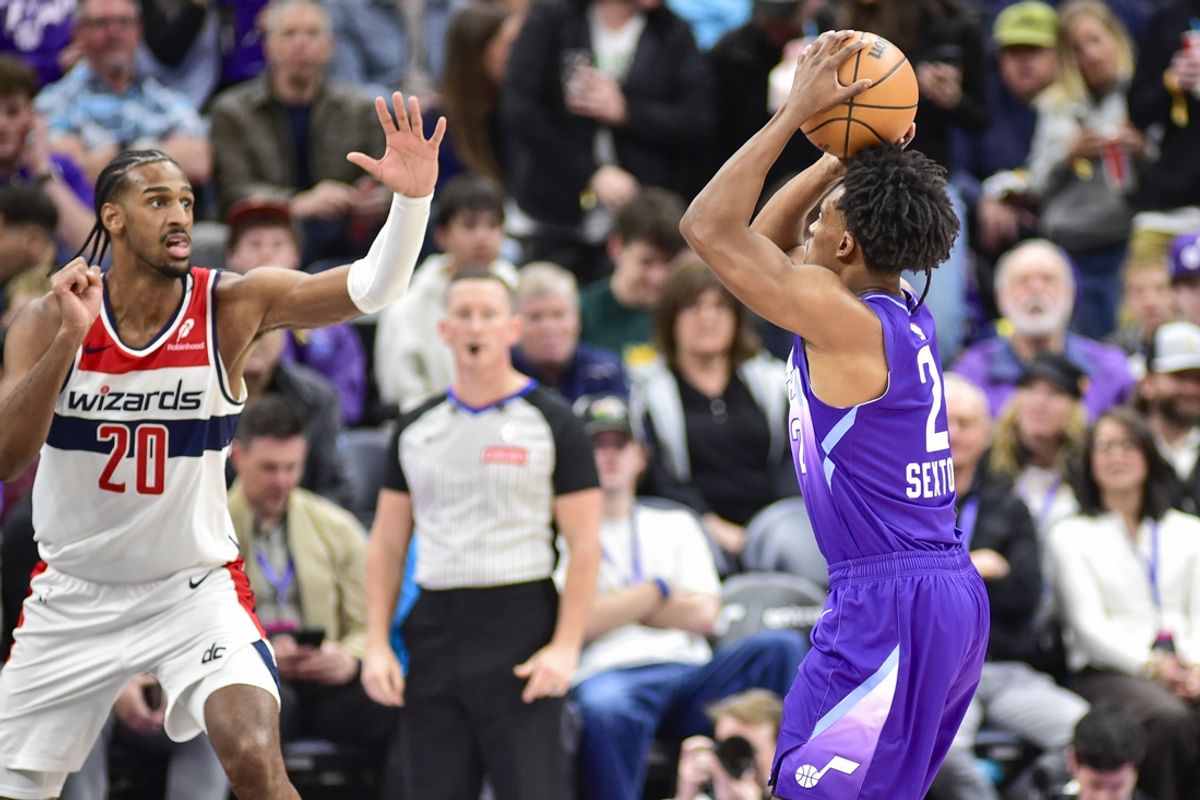 Mar 19, 2025; Salt Lake City, Utah, USA;  Utah Jazz guard Collin Sexton (2) makes three point attempt against Washington Wizards center Alex Sarr (20) during the first half at the Delta Center. Mandatory Credit: Peter Creveling-Imagn Images