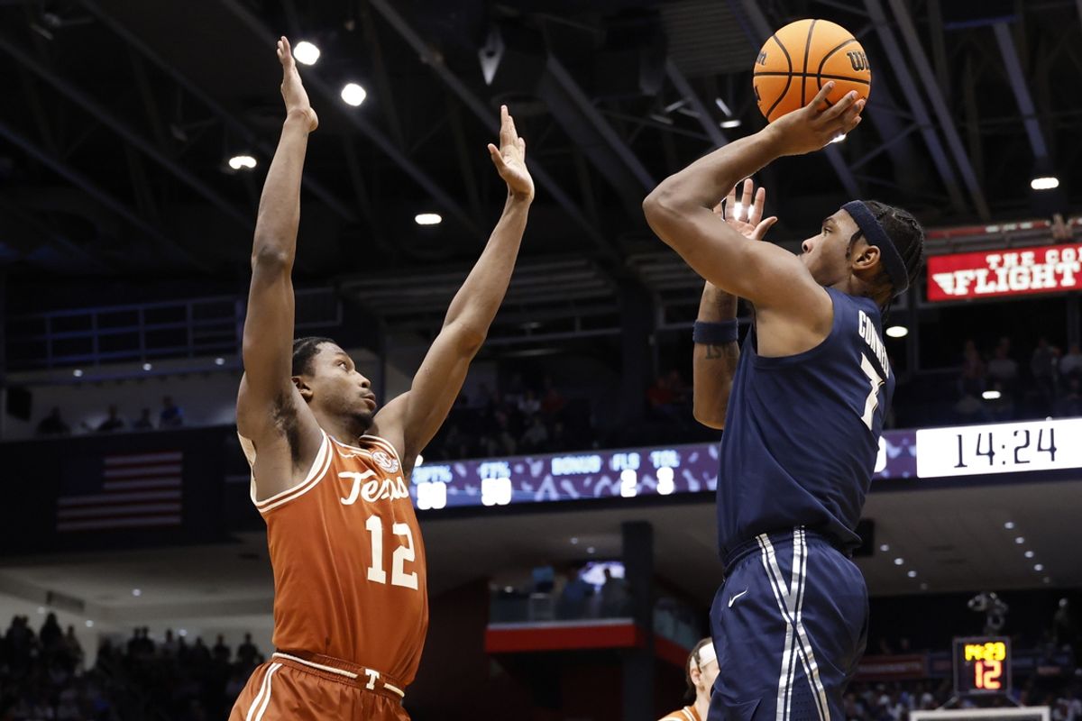 Mar 19, 2025; Dayton, OH, USA; Xavier Musketeers guard Ryan Conwell (7) shoots the ball over by Texas Longhorns guard Tramon Mark (12) in the second half at UD Arena. Mandatory Credit: Rick Osentoski-Imagn Images