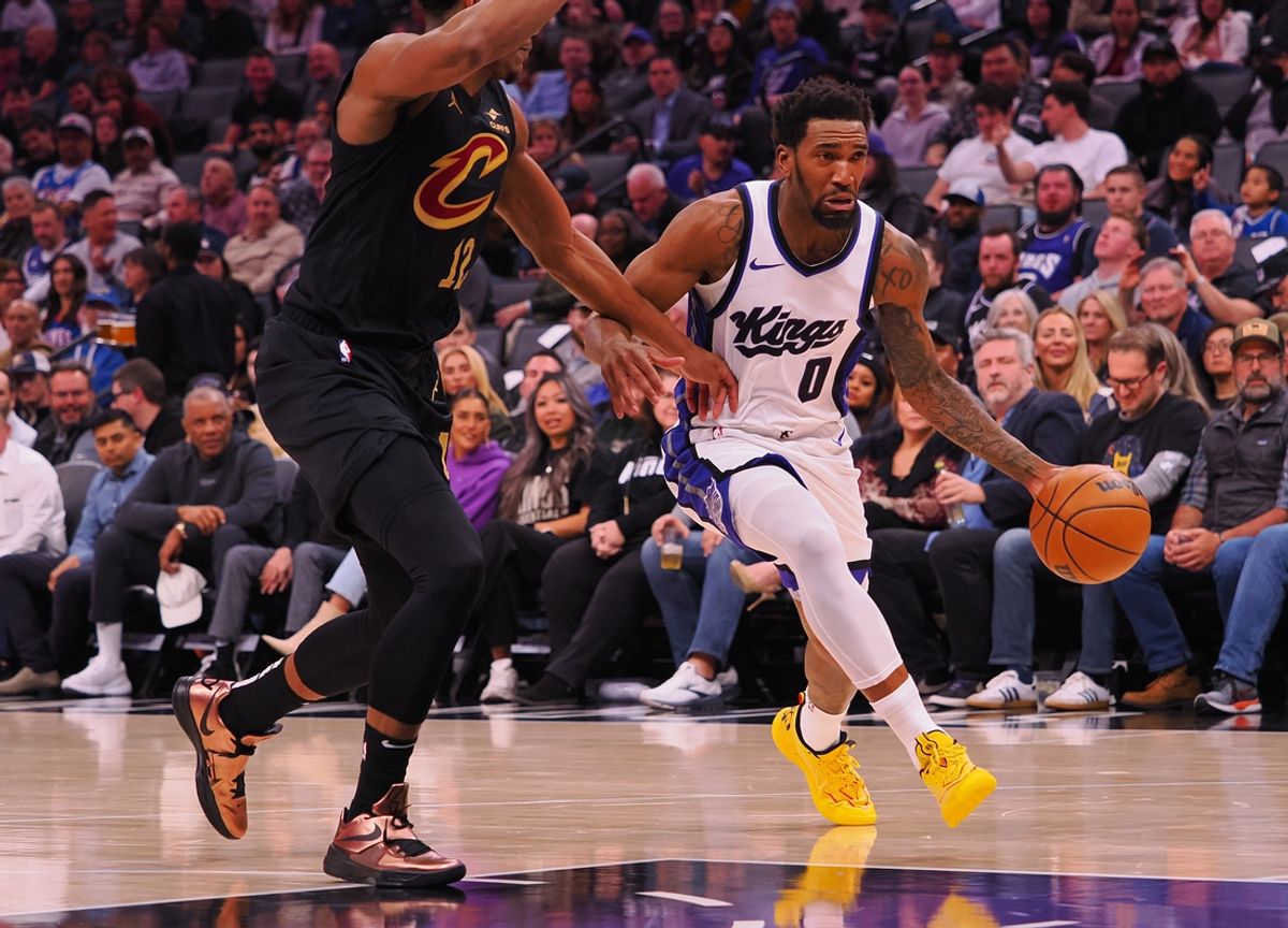 Mar 19, 2025; Sacramento, California, USA; Sacramento Kings guard Malik Monk (0) drives in against Cleveland Cavaliers forward De'Andre Hunter (12) during the first quarter at Golden 1 Center. Mandatory Credit: Kelley L Cox-Imagn Images