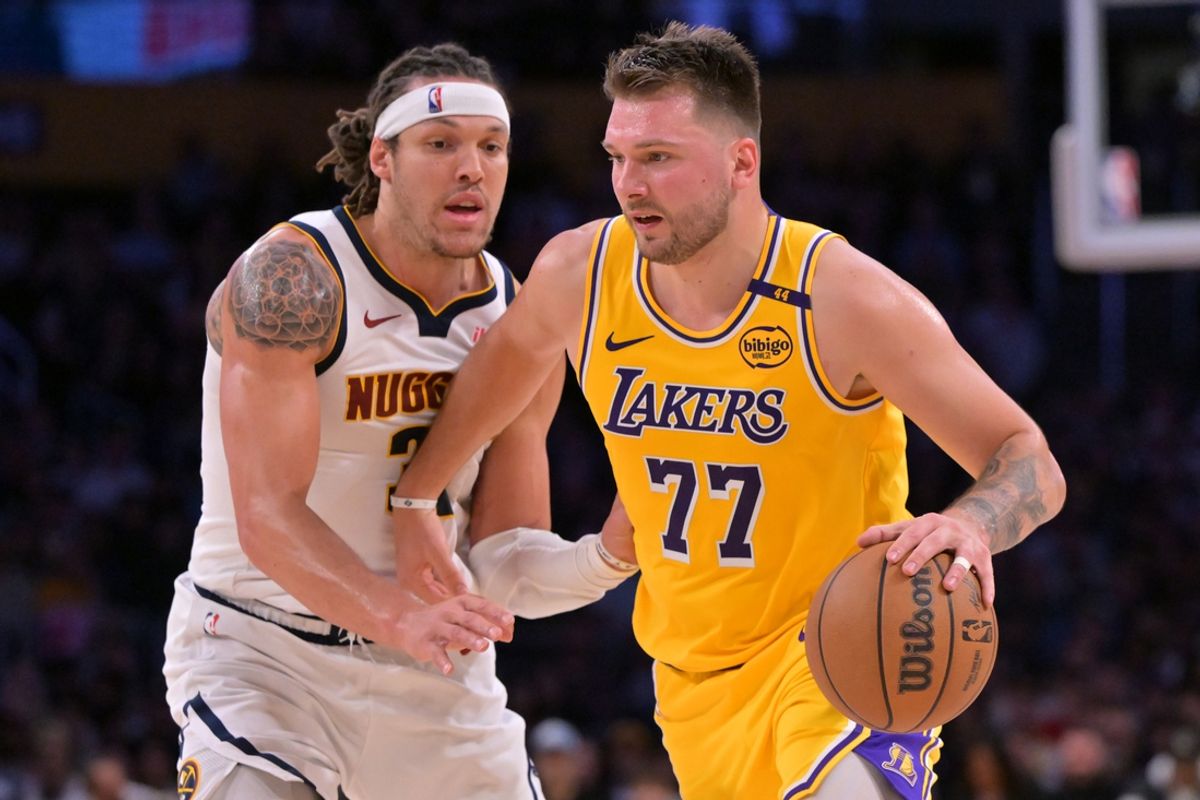 Mar 19, 2025; Los Angeles, California, USA;  Los Angeles Lakers guard Luka Doncic (77) is guarded by Denver Nuggets forward Aaron Gordon (32) in the first half at Crypto.com Arena. Mandatory Credit: Jayne Kamin-Oncea-Imagn Images