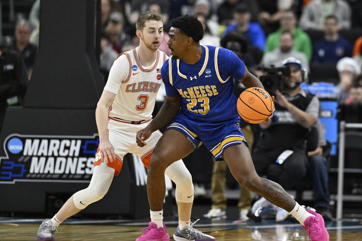 Mar 20, 2025; Providence, RI, USA; McNeese State Cowboys guard Brandon Murray (23) controls the ball against Clemson Tigers guard Jake Heidbreder (3) during the first half at Amica Mutual Pavilion. Mandatory Credit: Eric Canha-Imagn Images