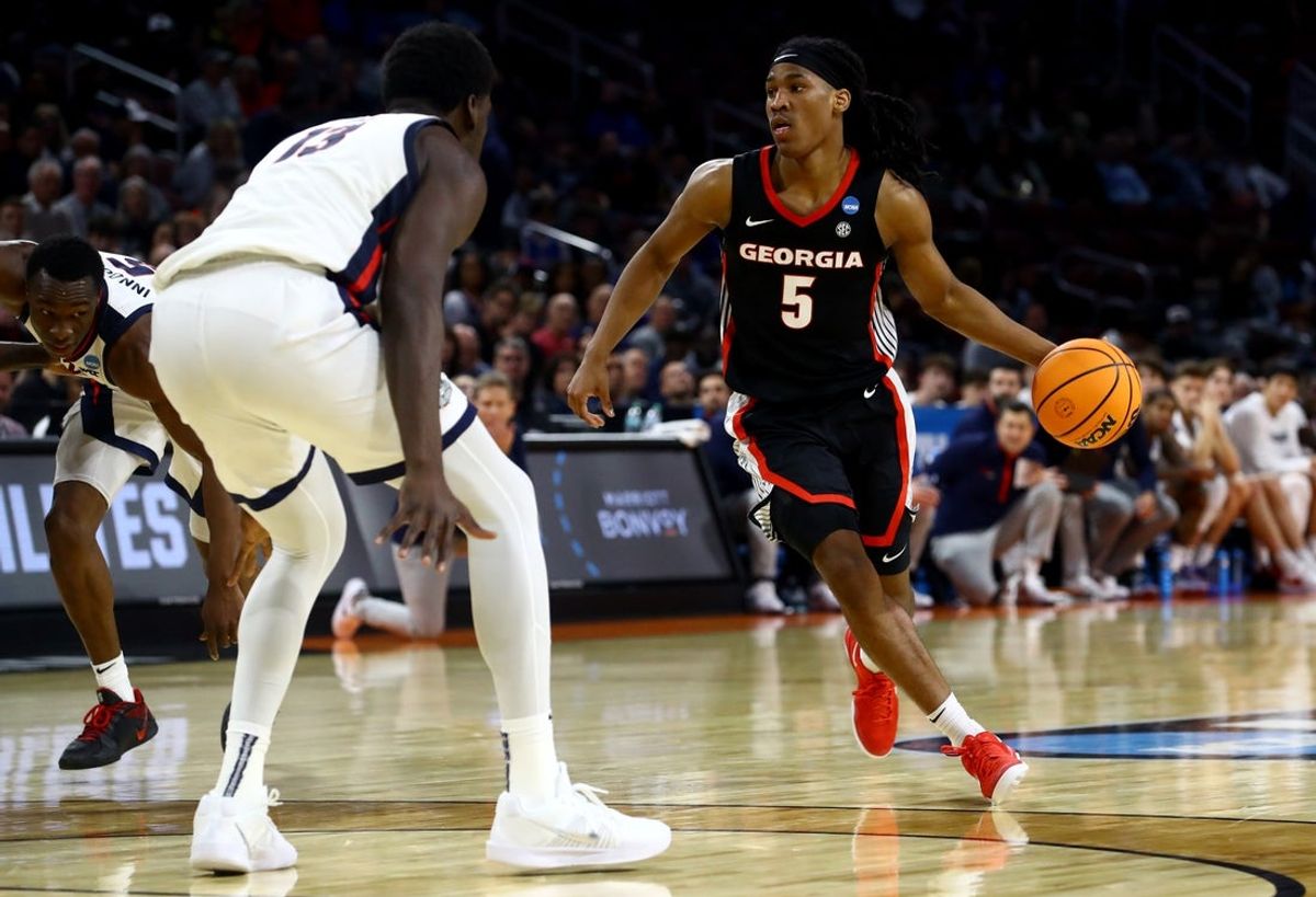 Mar 20, 2025; Wichita, KS, USA; Georgia Bulldogs guard Silas Demary Jr. (5) dribbles against Gonzaga Bulldogs forward Graham Ike (13) in the second half of a first round men’s NCAA Tournament game at Intrust Bank Arena. Mandatory Credit: Nick Tre. Smith-Imagn Images