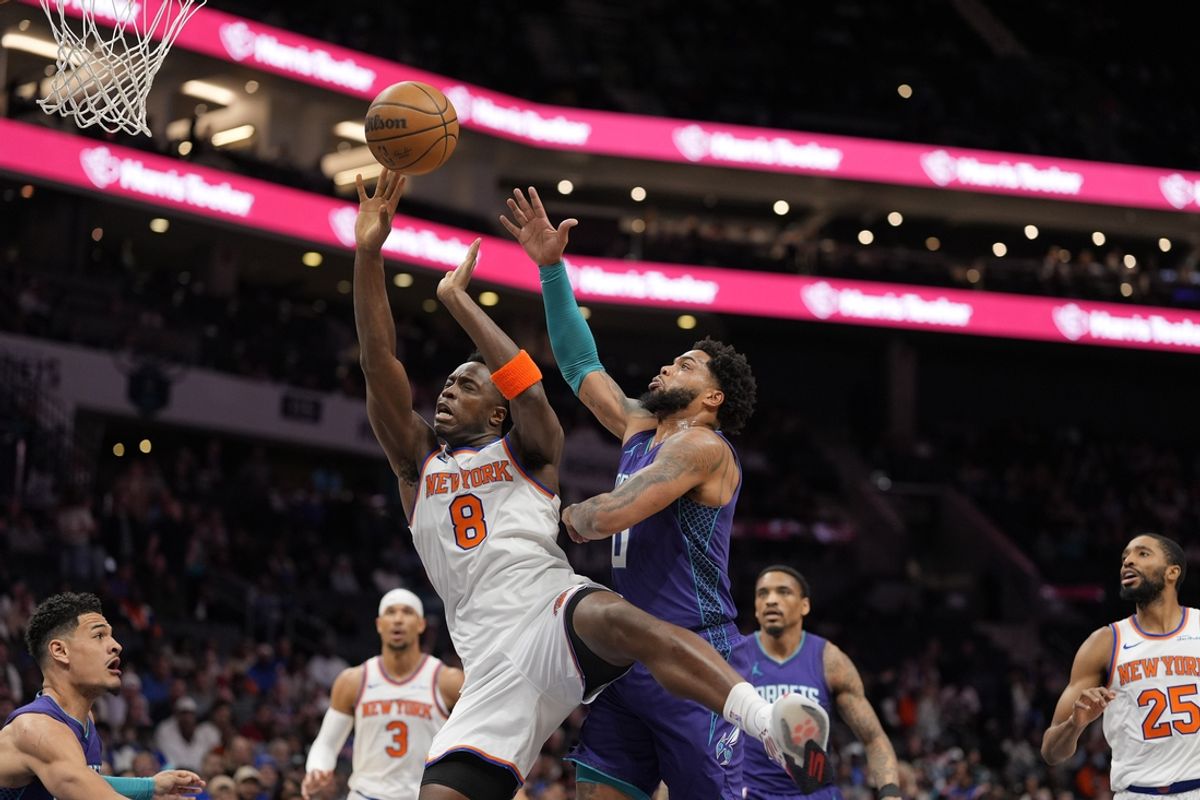 Mar 20, 2025; Charlotte, North Carolina, USA; New York Knicks forward OG Anunoby (8) collides with Charlotte Hornets forward Miles Bridges (0) on his way to the basket during the first quarter at Spectrum Center. Mandatory Credit: Jim Dedmon-Imagn Images