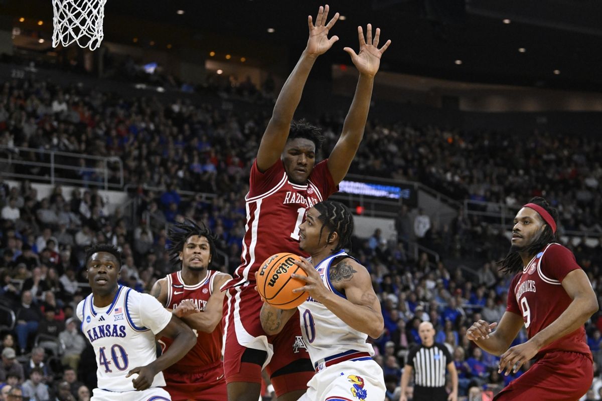 Mar 20, 2025; Providence, RI, USA;  Kansas Jayhawks guard Shakeel Moore (0) controls the ball against Arkansas Razorbacks forward Karter Knox (11) during the first half at Amica Mutual Pavilion. Mandatory Credit: Eric Canha-Imagn Images