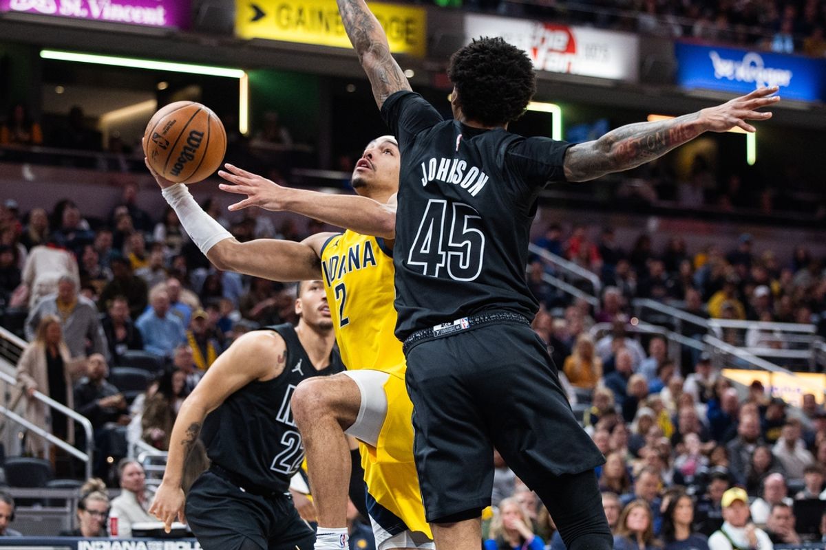Mar 20, 2025; Indianapolis, Indiana, USA; Indiana Pacers guard Andrew Nembhard (2) shoots the ball while Brooklyn Nets guard Keon Johnson (45) defends in the first half at Gainbridge Fieldhouse. Mandatory Credit: Trevor Ruszkowski-Imagn Images