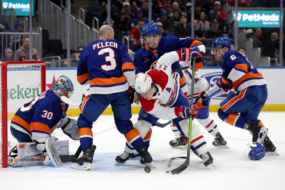 Mar 20, 2025; Elmont, New York, USA; Montreal Canadiens right wing Brendan Gallagher (11) fights for the puck against New York Islanders defensemen Adam Pelech (3) and Noah Dobson (8) and Ryan Pulock (6) and goaltender Ilya Sorokin (30) during the first period at UBS Arena. Mandatory Credit: Brad Penner-Imagn Images