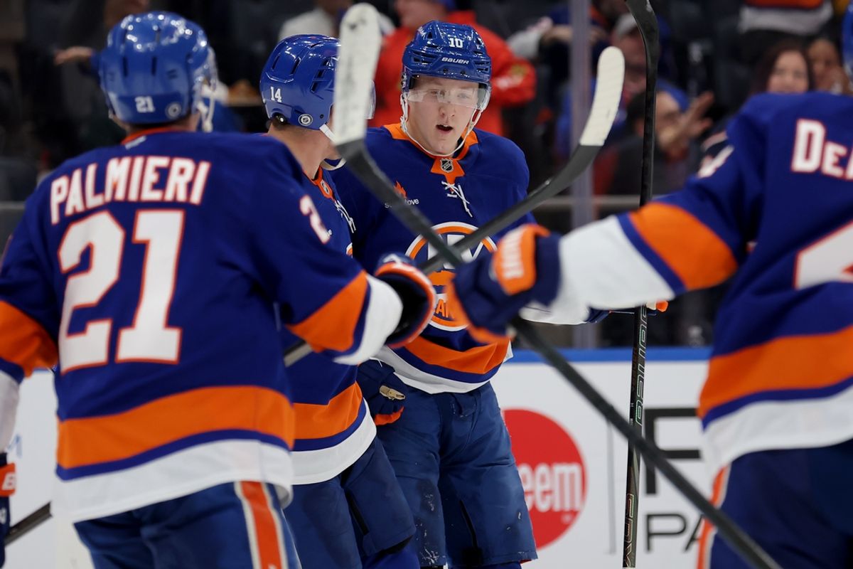 Mar 20, 2025; Elmont, New York, USA; New York Islanders right wing Simon Holmstrom (10) celebrates his goal against the Montreal Canadiens with centers Bo Horvat (14) and Kyle Palmieri (21) during the second period at UBS Arena. Mandatory Credit: Brad Penner-Imagn Images