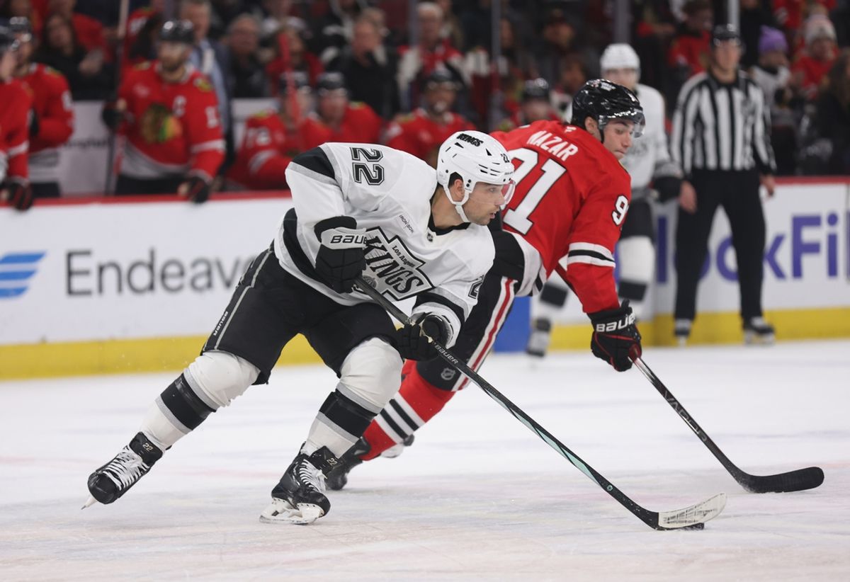 Mar 20, 2025; Chicago, Illinois, USA; Los Angeles Kings left wing Kevin Fiala (22) and Chicago Blackhawks center Frank Nazar (91) battle for control of the puck during the first period at United Center. Mandatory Credit: Talia Sprague-Imagn Images