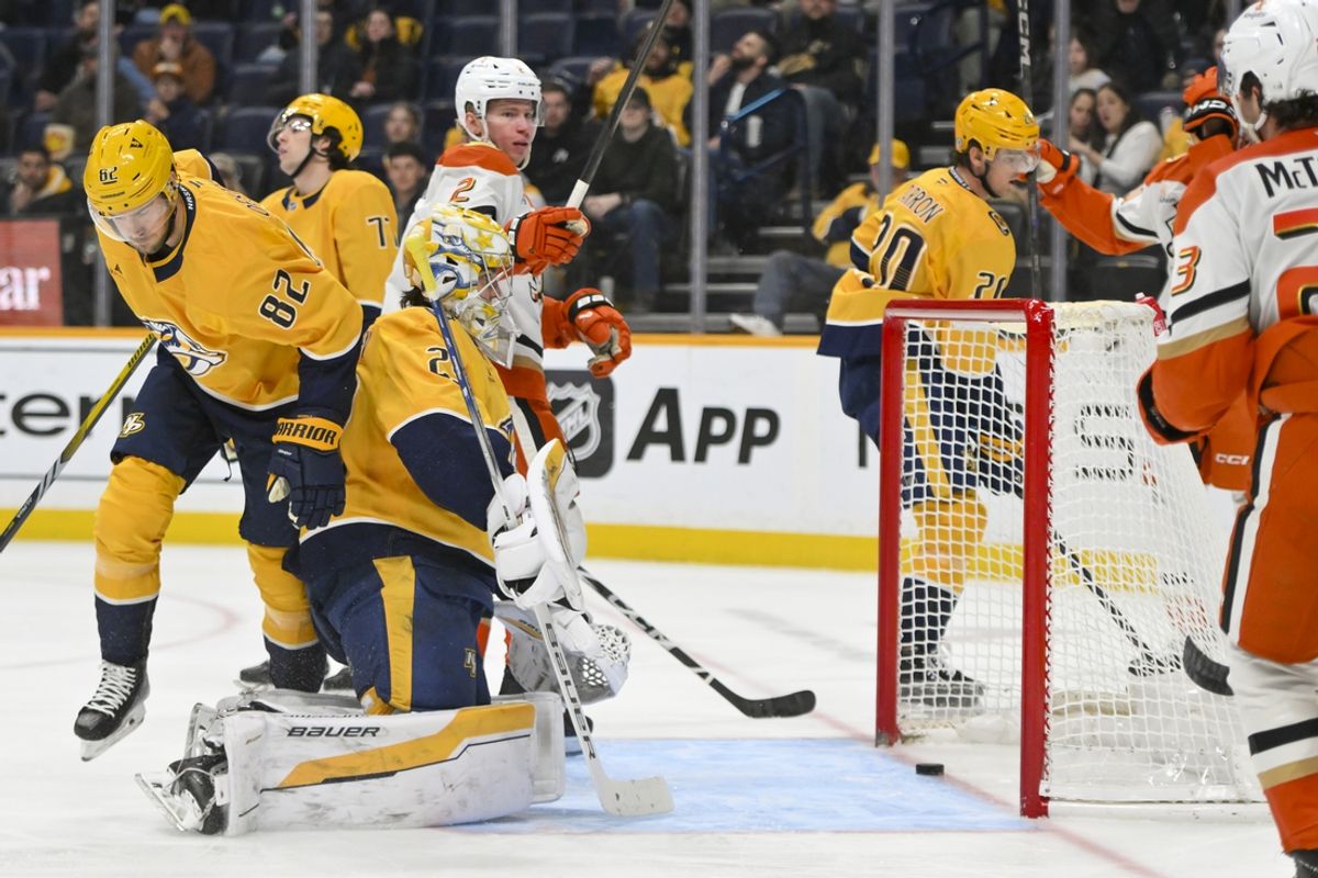 Mar 20, 2025; Nashville, Tennessee, USA;  Anaheim Ducks defenseman Jackson LaCombe (2) scores past Nashville Predators goaltender Justus Annunen (29) during the second period at Bridgestone Arena. Mandatory Credit: Steve Roberts-Imagn Images