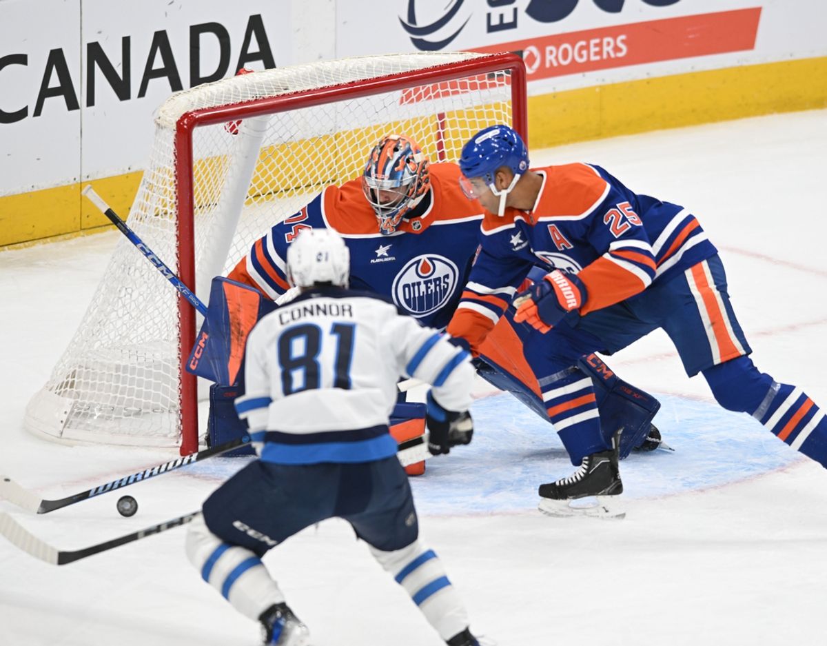 Mar 20, 2025; Edmonton, Alberta, CAN; Edmonton Oilers goalie Stuart Skinner (74) battles for the puck with Oilers defenceman Darnell Nurse (25) as Winnipeg Jets left winger Kyle Connor ( (81) skates towards them during the first period at Rogers Place. Mandatory Credit: Walter Tychnowicz-Imagn Images