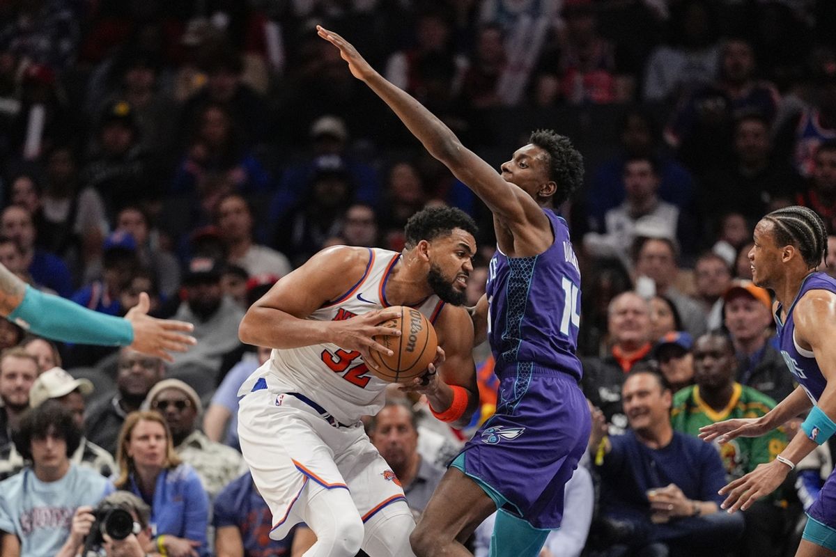Mar 20, 2025; Charlotte, North Carolina, USA; New York Knicks center Karl-Anthony Towns (32) presses against Charlotte Hornets forward Moussa Diabate (14) during the second half at Spectrum Center. Mandatory Credit: Jim Dedmon-Imagn Images
