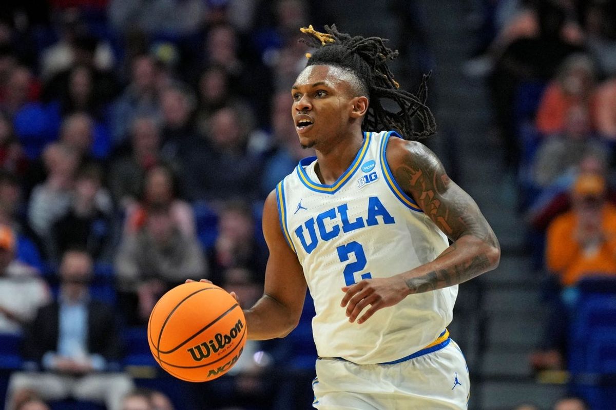 Mar 20, 2025; Lexington, KY, USA;  UCLA Bruins guard Dylan Andrews (2) brings the ball up court during the first half against the Utah State Aggies in the first round of the NCAA Tournament at Rupp Arena. Mandatory Credit: Aaron Doster-Imagn Images