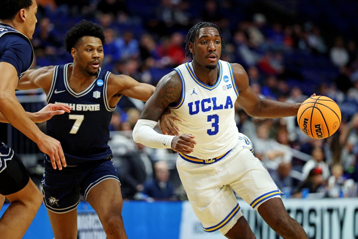 Mar 20, 2025; Lexington, KY, USA;  UCLA Bruins guard Eric Dailey Jr. (3) drives to the basket against Utah State Aggies guard Dexter Akanno (7) during the second half in the first round of the NCAA Tournament at Rupp Arena. Mandatory Credit: Jordan Prather-Imagn Images