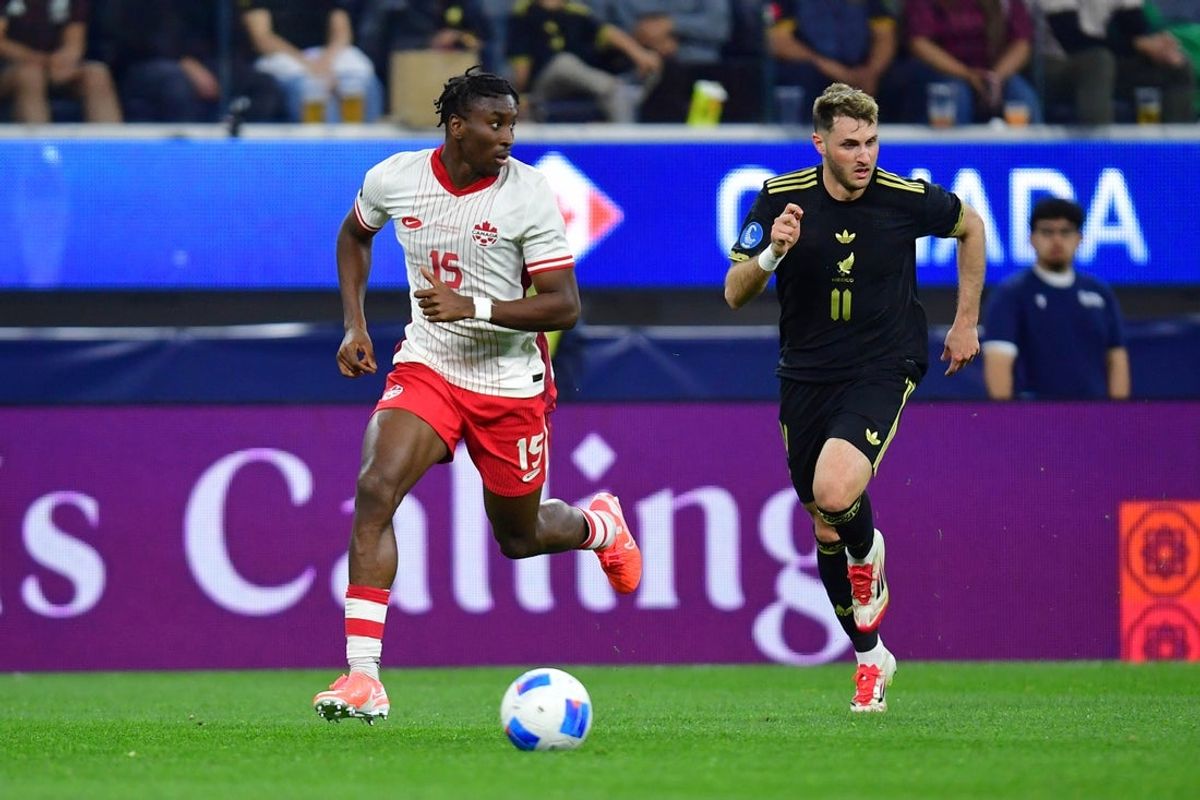 Mar 20, 2025; Inglewood, California, USA; Canada defender Moise Bombito (15) dribbles the ball against Mexico forward Santiago Gimenez (11) during the first half of a Concacaf Nations League semifinal match at SoFi Stadium. Mandatory Credit: Gary A. Vasquez-Imagn Images