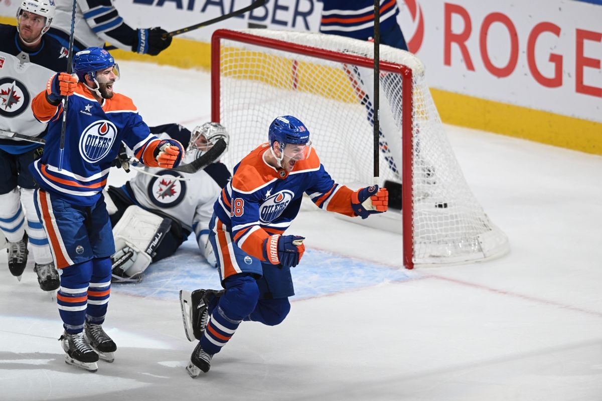 Mar 20, 2025; Edmonton, Alberta, CAN; Edmonton Oilers center Adam Henrique (19 ) along with Oilers left winger Zach Hyman (18) celebrates a goal on Winnipeg Jets goalie Connor Hellebuyck (37) during the third period at Rogers Place. Mandatory Credit: Walter Tychnowicz-Imagn Images