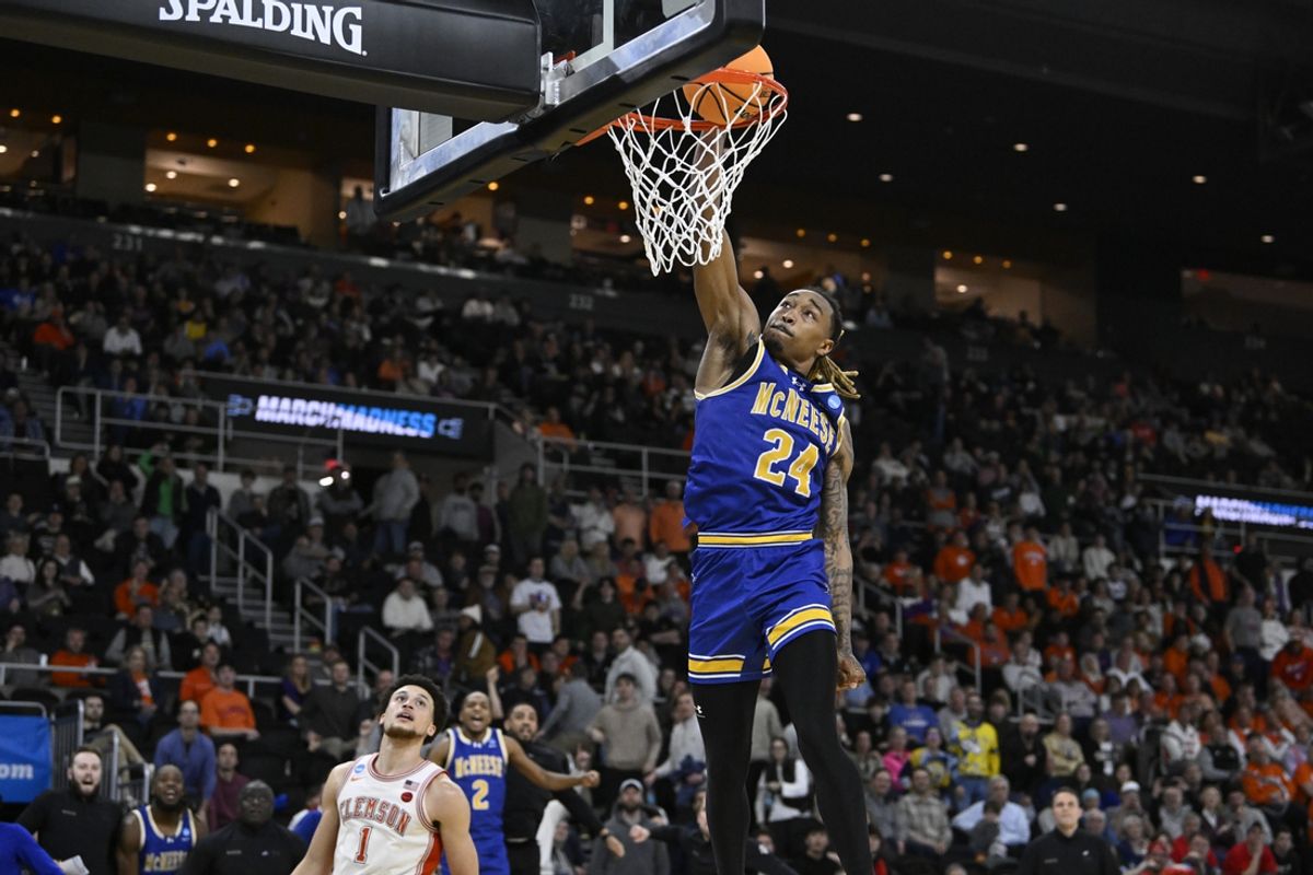 Mar 20, 2025; Providence, RI, USA; McNeese State Cowboys forward Christian Shumate (24) dunks against Clemson Tigers guard Chase Hunter (1) during the second half at Amica Mutual Pavilion. Mandatory Credit: Eric Canha-Imagn Images