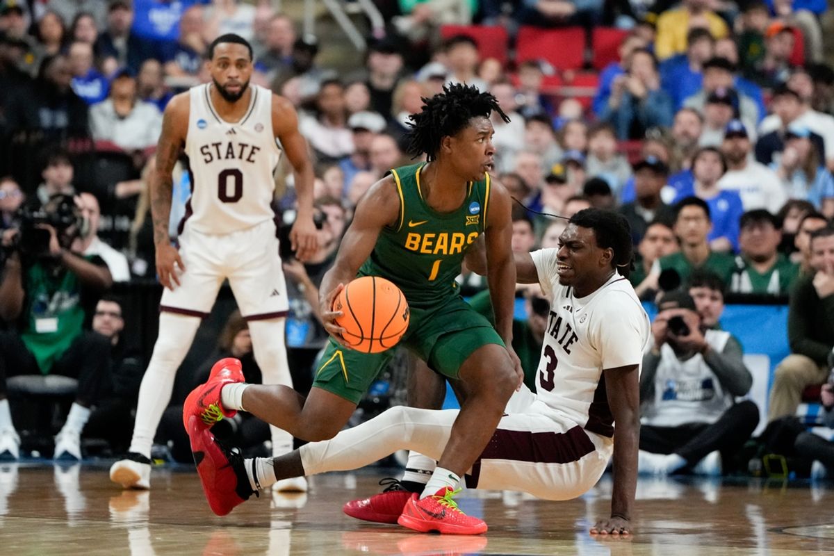 Mar 21, 2025; Raleigh, NC, USA; Baylor Bears guard Robert Wright III (1) dribbles the ball against Mississippi State Bulldogs forward KeShawn Murphy (3) during the second half in the first round of the NCAA Tournament at Lenovo Center. Mandatory Credit: Bob Donnan-Imagn Images