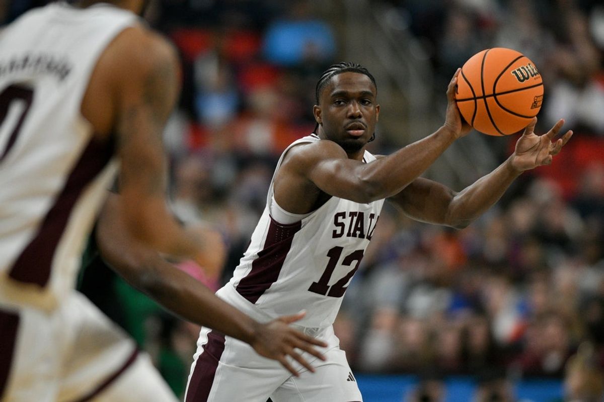 Mar 21, 2025; Raleigh, NC, USA; Mississippi State Bulldogs guard Josh Hubbard (12) passes the ball against the Baylor Bears during the first half in the first round of the NCAA Tournament at Lenovo Center. Mandatory Credit: Zachary Taft-Imagn Images