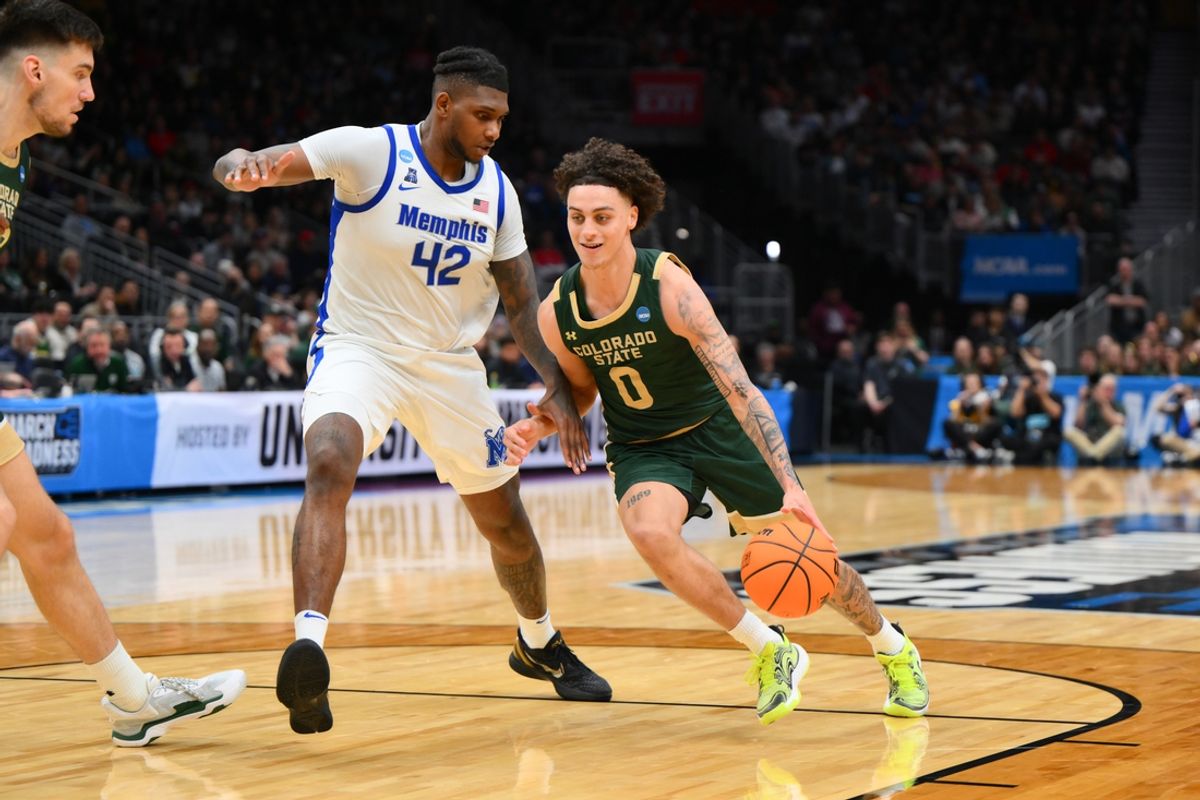 Mar 21, 2025; Seattle, WA, USA; Colorado State Rams guard Kyan Evans (0) drives past Memphis Tigers forward Dain Dainja (42) during the first half at Climate Pledge Arena. Mandatory Credit: Steven Bisig-Imagn Images
