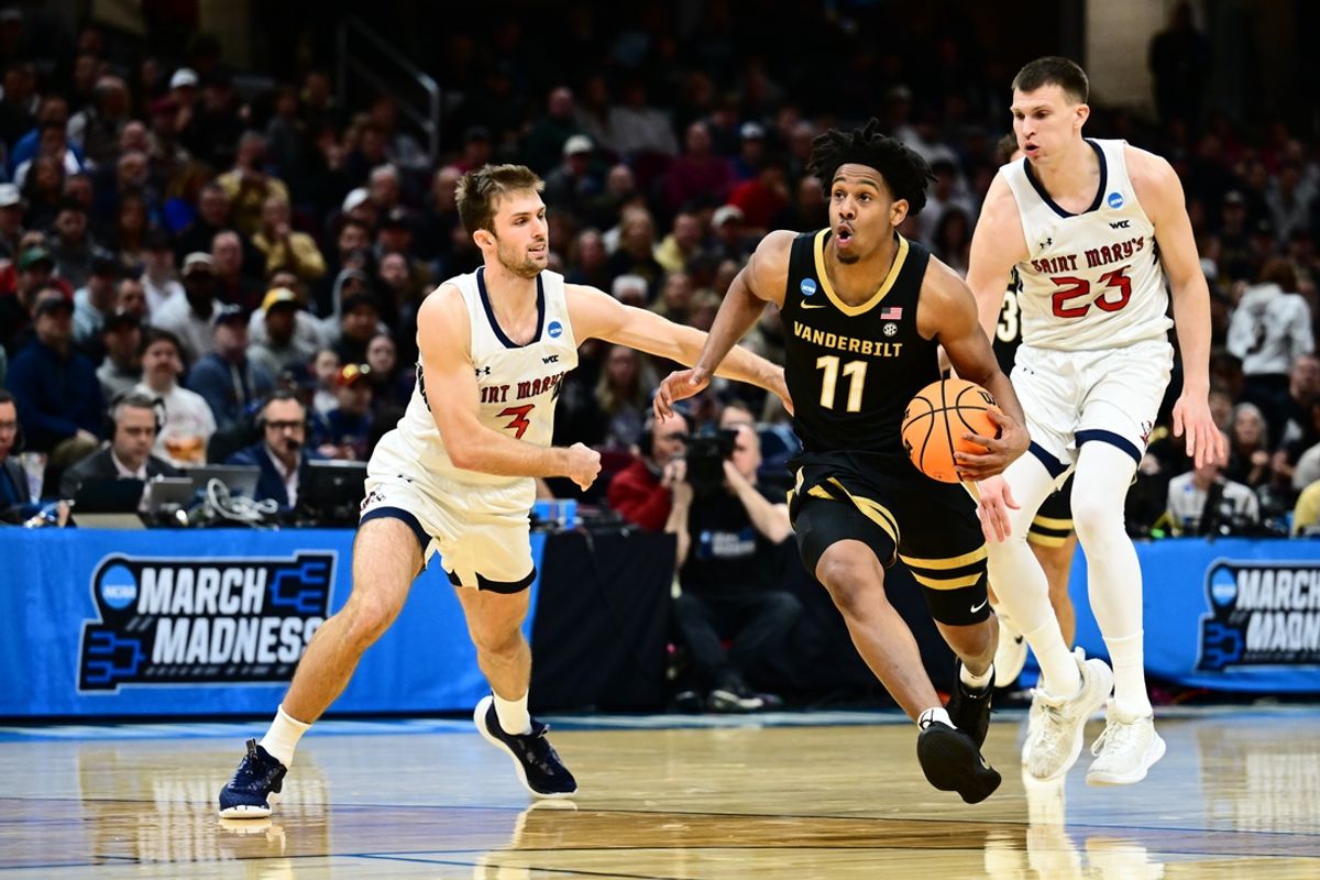 Mar 21, 2025; Cleveland, OH, USA; Vanderbilt Commodores guard AJ Hoggard (11) dribbles the ball defended by St. Mary's Gaels guard Augustas Marciulionis (3) in the first half at Rocket Arena. Mandatory Credit: Ken Blaze-Imagn Images