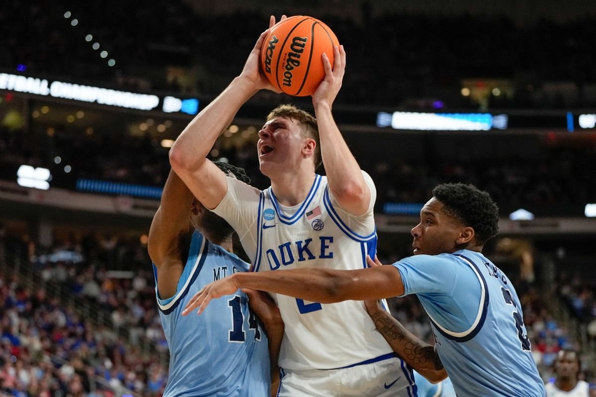 Mar 21, 2025; Raleigh, NC, USA; Mount St. Mary's Mountaineers forward Jedy Cordilia (14) and guard Arlandus Keyes (2) defend against Duke Blue Devils forward Cooper Flagg (2) during the first half in the first round of the NCAA Tournament at Lenovo Center. Mandatory Credit: Bob Donnan-Imagn Images