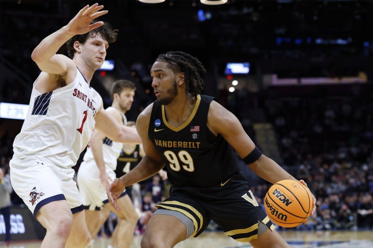 Mar 21, 2025; Cleveland, OH, USA; Vanderbilt Commodores forward Devin McGlockton (99) plays the ball defended by St. Mary's Gaels center Harry Wessels (1) in the second half at Rocket Arena. Mandatory Credit: Rick Osentoski-Imagn Images