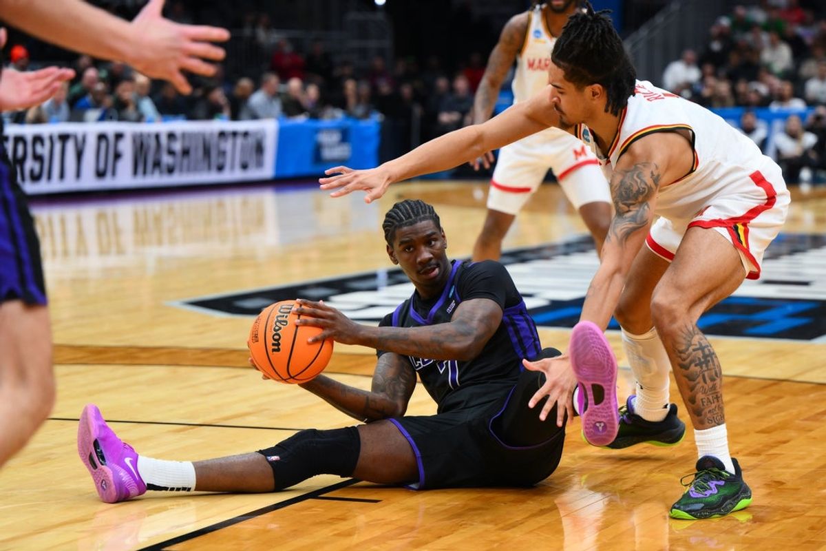 Mar 21, 2025; Seattle, WA, USA; Grand Canyon Antelopes guard Tyon Grant-Foster (7) grabs a loose ball while being defended by Maryland Terrapins guard Rodney Rice (1) during the second half at Climate Pledge Arena. Mandatory Credit: Steven Bisig-Imagn Images