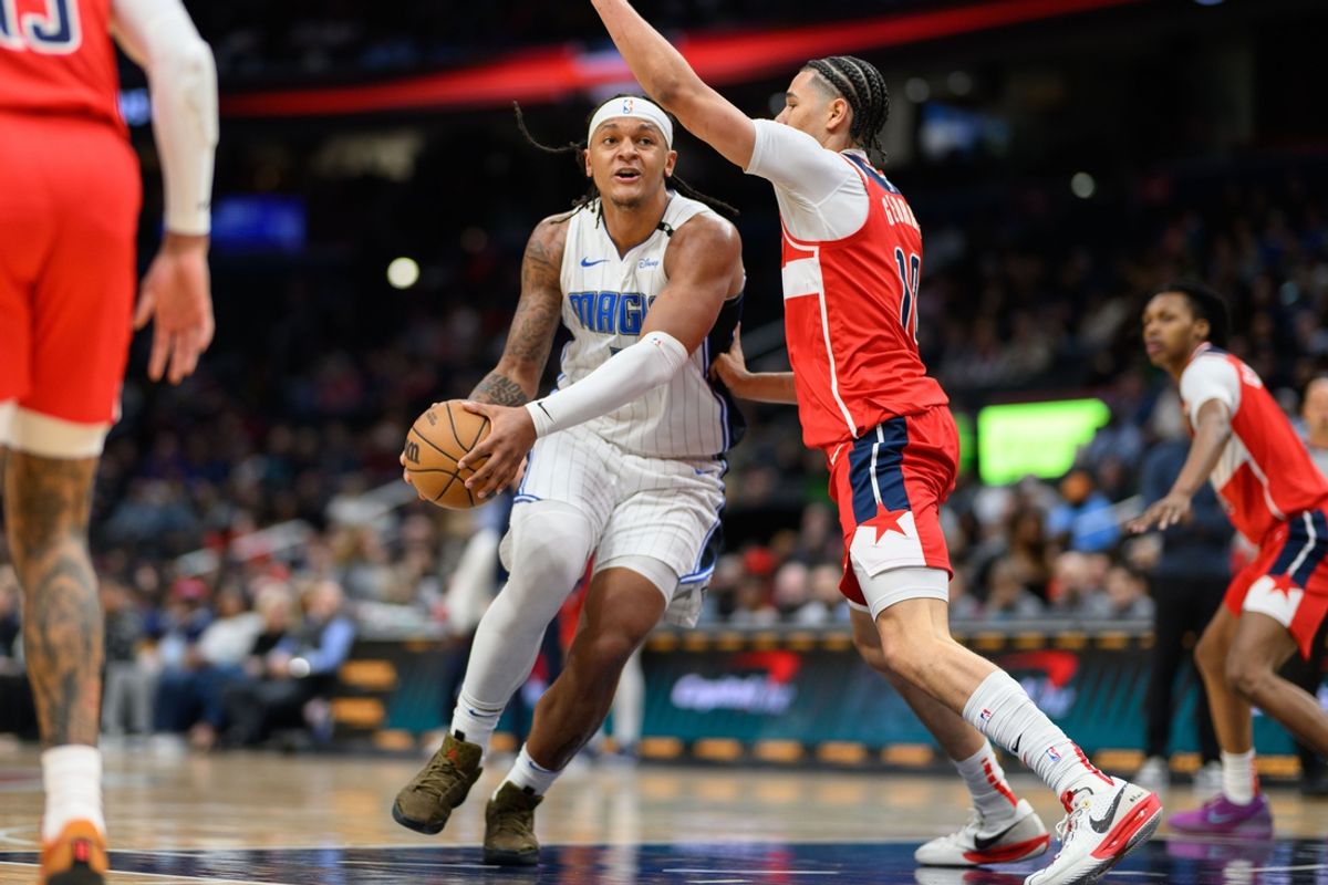 Mar 21, 2025; Washington, District of Columbia, USA; Orlando Magic forward Paolo Banchero (5) drives to the basket against Washington Wizards forward Kyshawn George (18) during the second quarter at Capital One Arena. Mandatory Credit: Reggie Hildred-Imagn Images