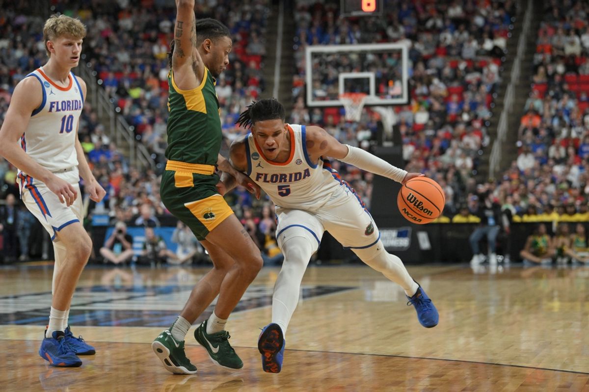 Mar 21, 2025; Raleigh, NC, USA;  Florida Gators guard Will Richard (5) controls the ball against Norfolk State Spartans during the second half at Lenovo Center. Mandatory Credit: Zachary Taft-Imagn Images