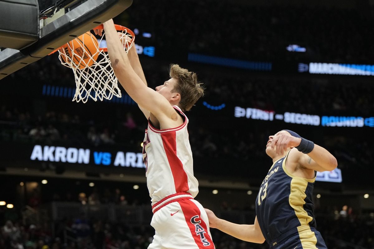 Mar 21, 2025; Seattle, WA, USA; Arizona Wildcats forward Henri Veesaar (13) dunks the ball against Akron Zips guard Isaiah Gray (13) during the second half in the first round of the NCAA Tournament at Climate Pledge Arena. Mandatory Credit: Stephen Brashear-Imagn Images
