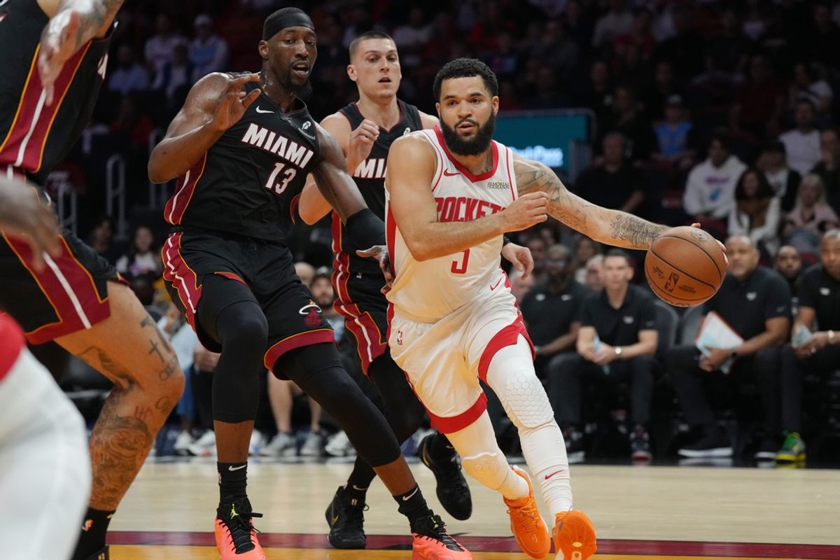Mar 21, 2025; Miami, Florida, USA;  Houston Rockets guard Fred VanVleet (5) drives past Miami Heat center Bam Adebayo (13) in the first half at Kaseya Center. Mandatory Credit: Jim Rassol-Imagn Images