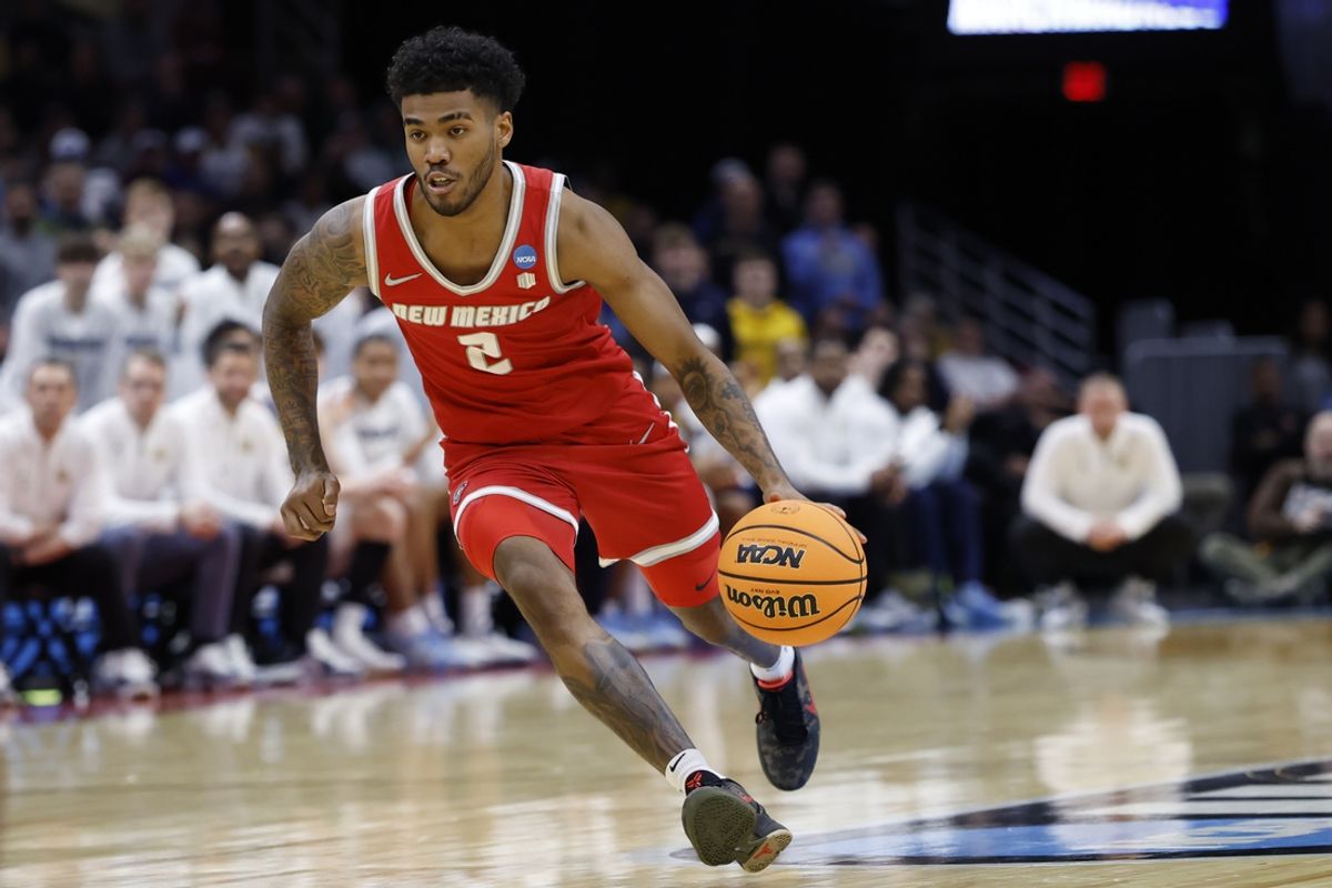 Mar 21, 2025; Cleveland, OH, USA; New Mexico Lobos guard Donovan Dent (2) dribbles the ball in the second half against the Marquette Golden Eagles during the NCAA Tournament First Round at Rocket Arena. Mandatory Credit: Rick Osentoski-Imagn Images