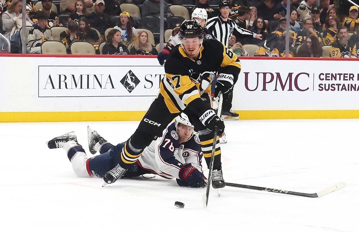 Mar 21, 2025; Pittsburgh, Pennsylvania, USA;  Pittsburgh Penguins right wing Rickard Rakell (67) moves the puck against Columbus Blue Jackets defenseman Damon Severson (78) during the third period at PPG Paints Arena. Mandatory Credit: Charles LeClaire-Imagn Images