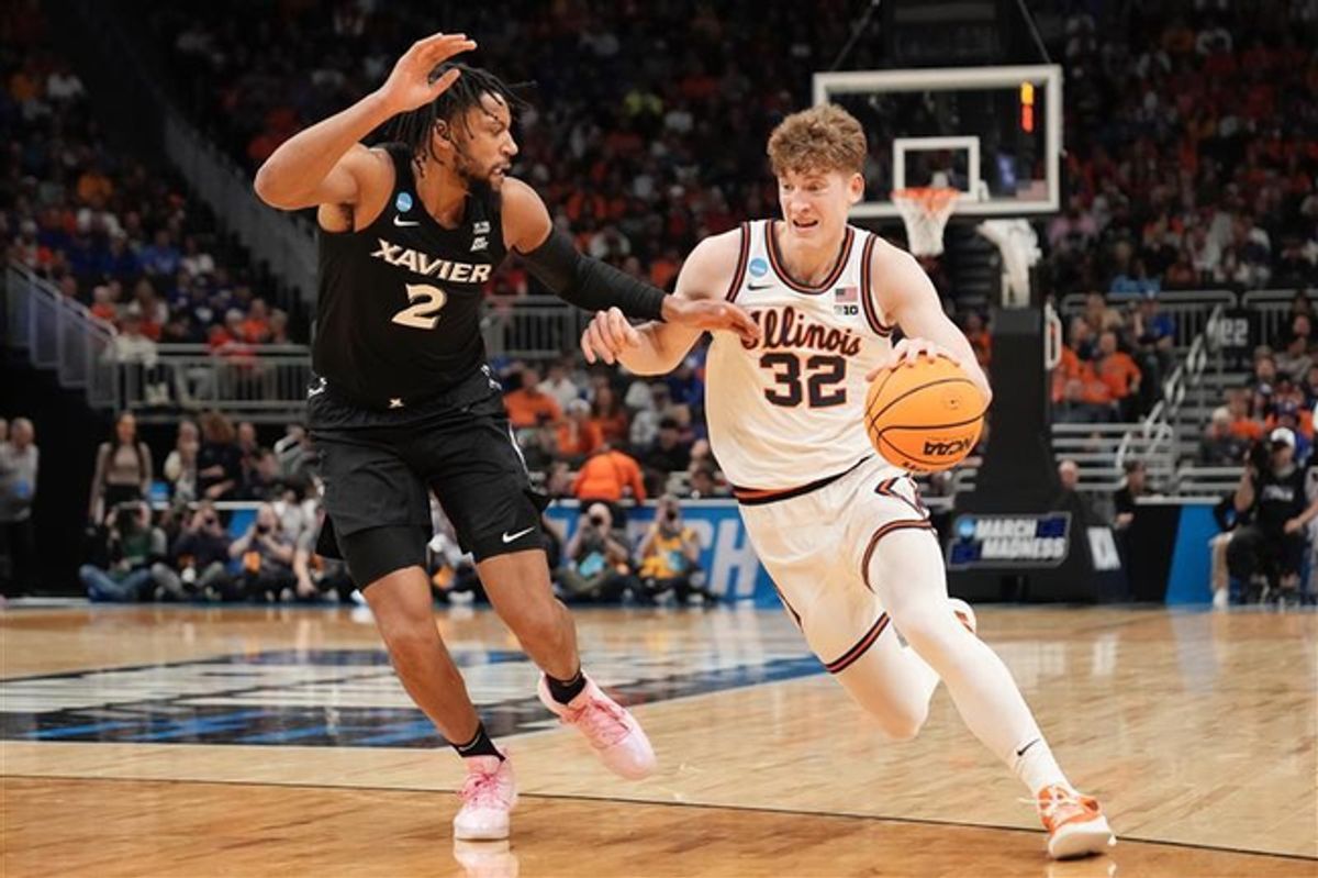 Illinois guard Kasparas Jakucionis (32) drives to the basket against Xavier forward Jerome Hunter (2) in an NCAA Tournament game at Fiserv Forum in Milwaukee, Wisconsin on Friday, March 21, 2025.