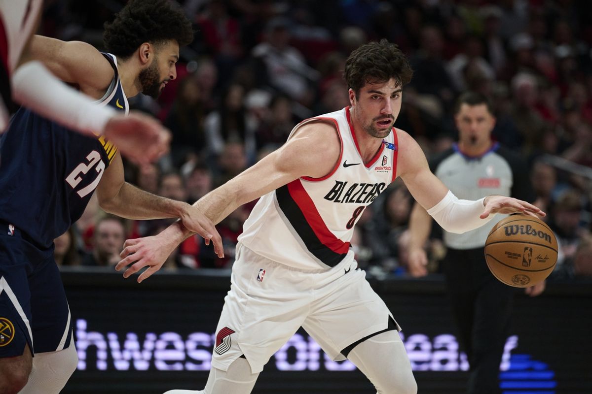 Mar 21, 2025; Portland, Oregon, USA; Portland Trail Blazers forward Deni Avdija (8) dribbles the ball during the first half against Denver Nuggets guard Jamal Murray (27) at Moda Center. Mandatory Credit: Troy Wayrynen-Imagn Images